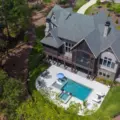 aerial view of luxurious style home with swimming pool in front - custom home builder | Southern Luxury Homes