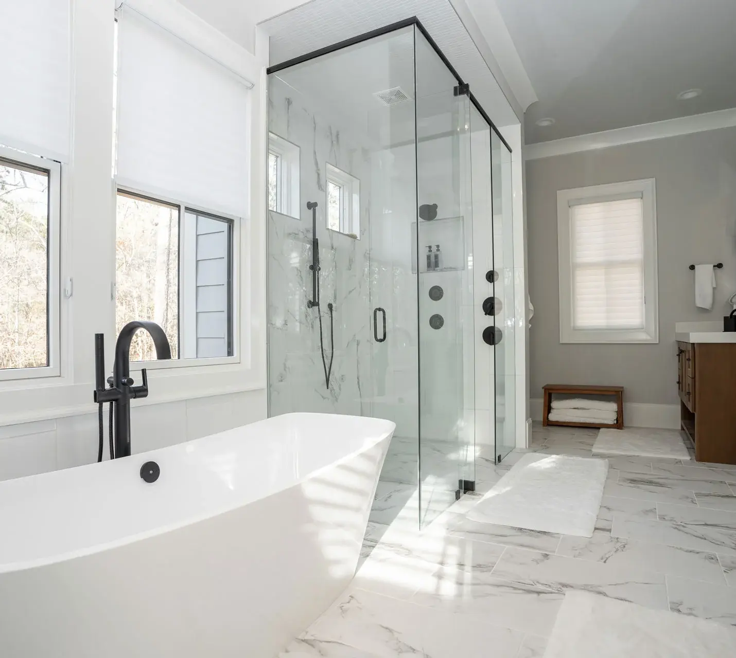 image of modern style bathroom with bathtub and big mirror -custom home builder