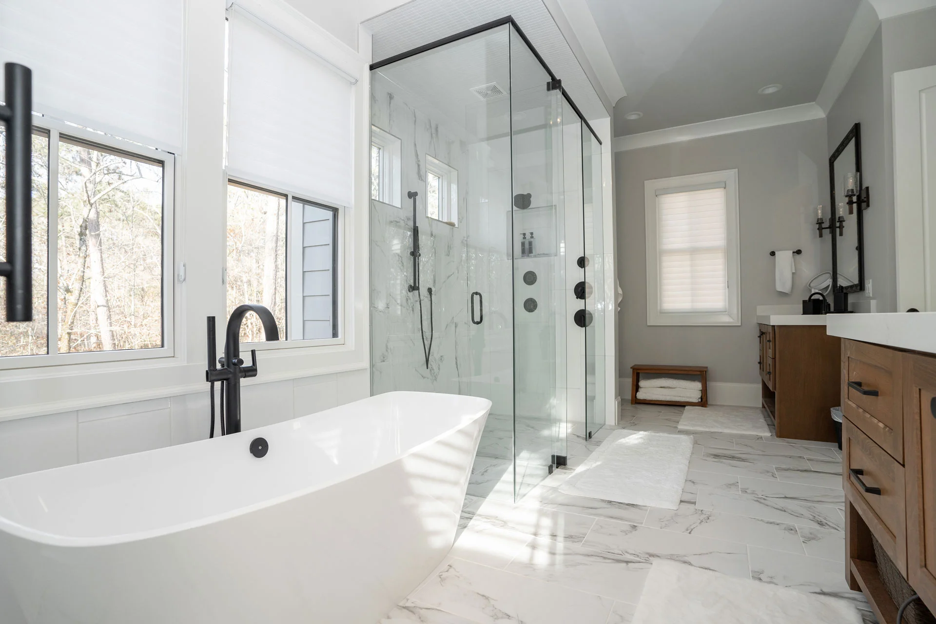 image of modern style bathroom with bathtub and big mirror -custom home builder | Southern Luxury Homes