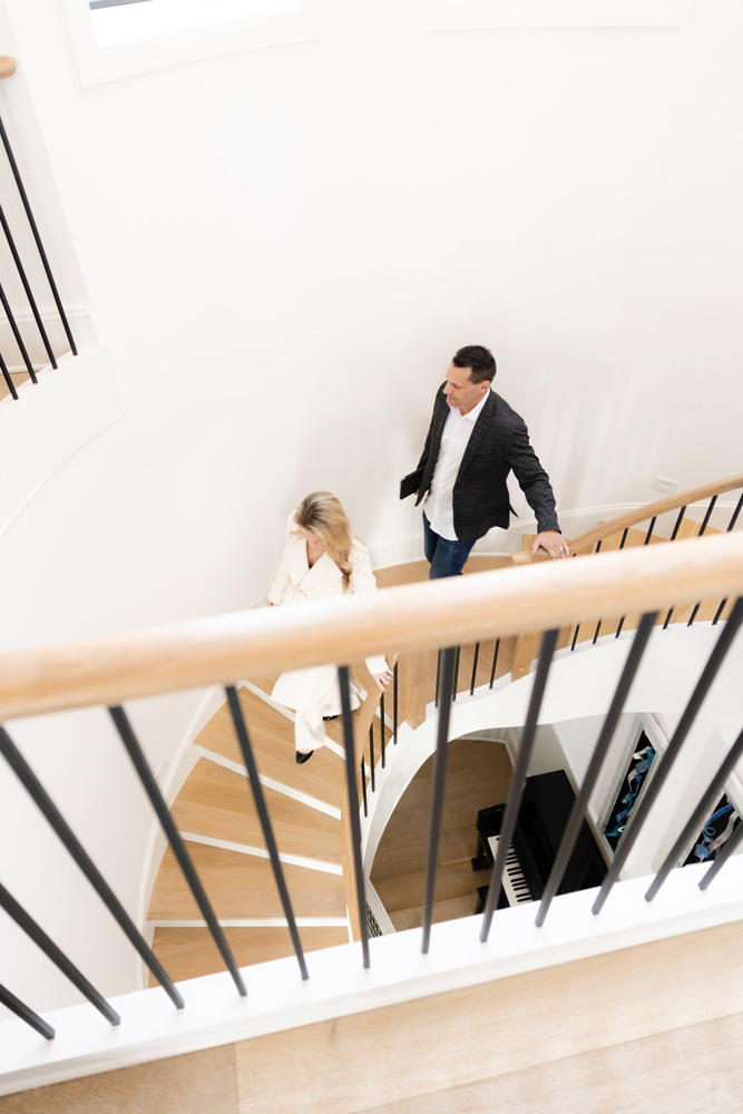 2 people going down using stair | Southern Luxury Homes