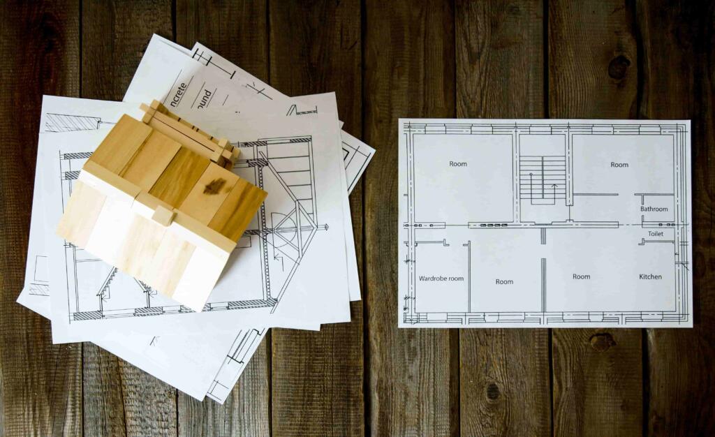 tinywow_many-drawings-for-building-and-house-on-old-wooden-2024-11-01-10-51-17-utc_85906246 Southern Luxury Homes Picture of Floor Plan | Southern Luxury Homes